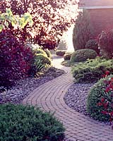 The egg-sized river cobbles over landscape fabric created a very sterile feel to the plantings. The cobbles and fabric were removed and replaced with double milled hardwood bark mulch.