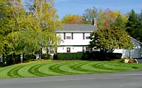 Lawn striping is achieved by bending grass blades in different directions to reflect sunlight.